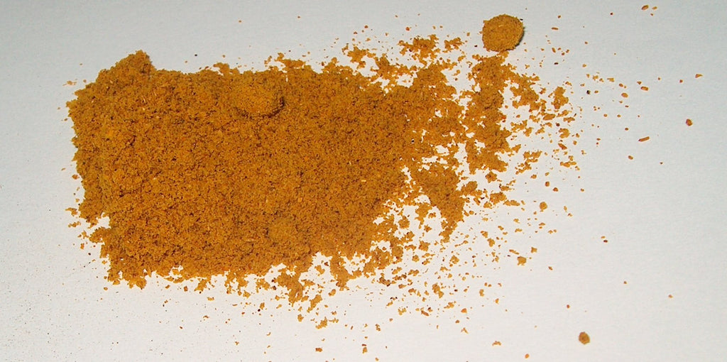 Madras curry powder, golden-orange finely ground spice blend. Photo by Henna via Wikimedia Commons, CC BY-SA 1.0.