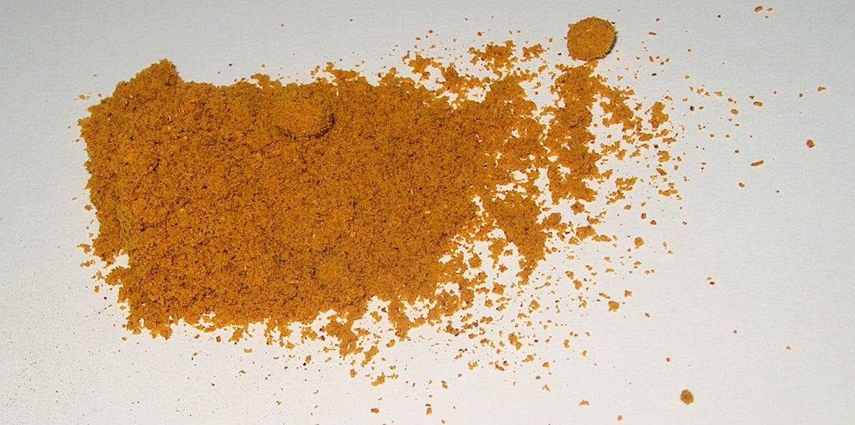 Madras curry powder, golden-orange finely ground spice blend. Photo by Henna via Wikimedia Commons, CC BY-SA 1.0.