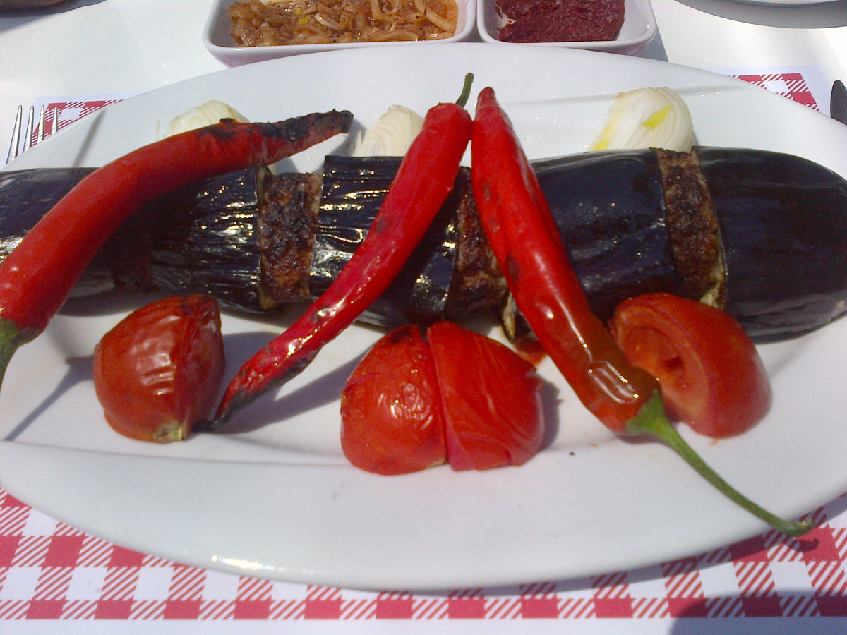 Turkish eggplant kebab served with Urfa pepper isot, a direct traditional use for Spice Czar Urfa Biber Chile Flakes. Wikimedia Commons image.