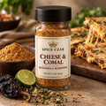 Spice Czar Cheese & Comal Quesadilla Seasoning in a 2 oz round glass shaker, shown with dried ancho chile, a lime half and Mexican oregano beside a cut quesadilla