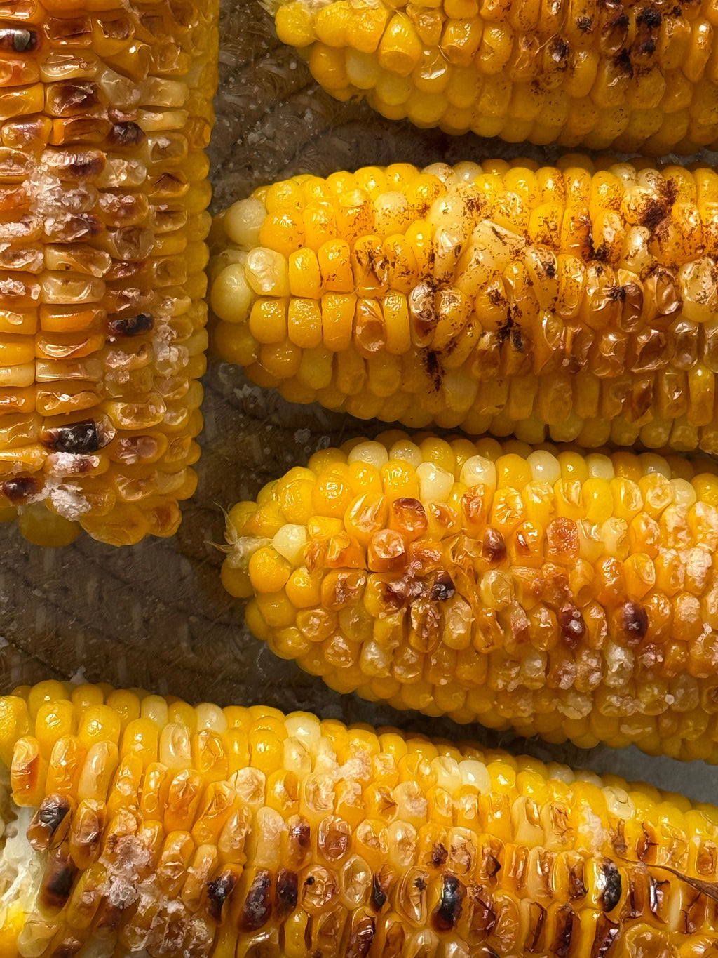 Grilled corn on the cob with butter and seasoning