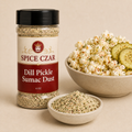 Dill Pickle Sumac Dust in labeled 4 oz shaker with loose seasoning and seasoned popcorn
