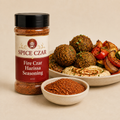 Fire Czar Harissa Seasoning in labeled 4 oz shaker with loose seasoning, falafel, hummus, and roasted vegetables