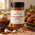 Spice Czar Garlic Mushroom Onion Smoked Chipotle Seasoning in a 2 oz round glass shaker, shown with dried chipotle chiles and garlic beside a plate of chicken wings