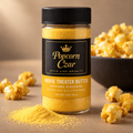 Popcorn Czar Movie Theater Butter popcorn seasoning in a 2 oz round shaker with a butter-yellow flavour band, shown with buttered popcorn
