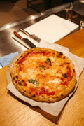 Freshly baked Margherita pizza with tomato, mozzarella and basil, a signature use for Spice Czar Naples Seasoning.