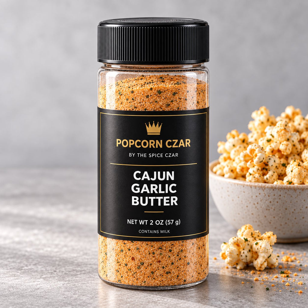Product visualization of Popcorn Czar Cajun Garlic Butter in a round 2 oz shaker with a black-and-gold label beside seasoned popcorn. Actual batch shade may vary.