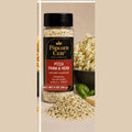 Popcorn Czar Pizza Parm & Herb 2 oz seasoning with Parmesan, tomato, garlic, oregano, and basil texture beside popcorn