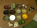 Assortment of whole and ground spices including dried chile, ginger, cinnamon, coriander, cloves, cumin and black pepper, representing the layered profile of Spice Czar 18 Spice Chicken Rub. Photo by Zak Greant via Wikimedia Commons, CC BY 2.0.