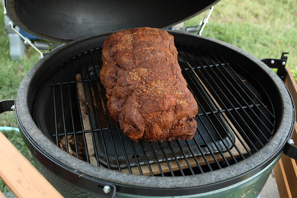 Pork shoulder coated with a spice rub on a smoker, a barbecue use idea for Spice Czar All American Dry Rub. Photo via Wikimedia Commons.