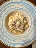 Serving suggestion for Cacio e Pepe Seasoning: pasta with grated cheese and black pepper, without herbs. Photo by Luca Volpe Productions/Pexels; not a photograph of the dry blend.