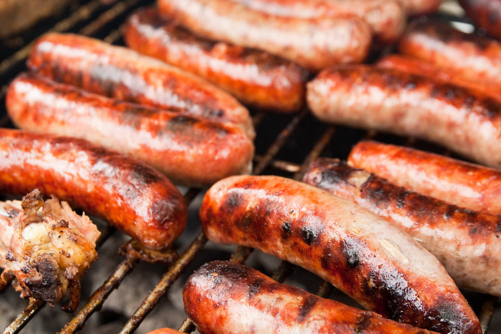 Italian sausage cooking on a grill, a classic fennel-seed use for Spice Czar Fennel Seeds. Wikimedia Commons image.