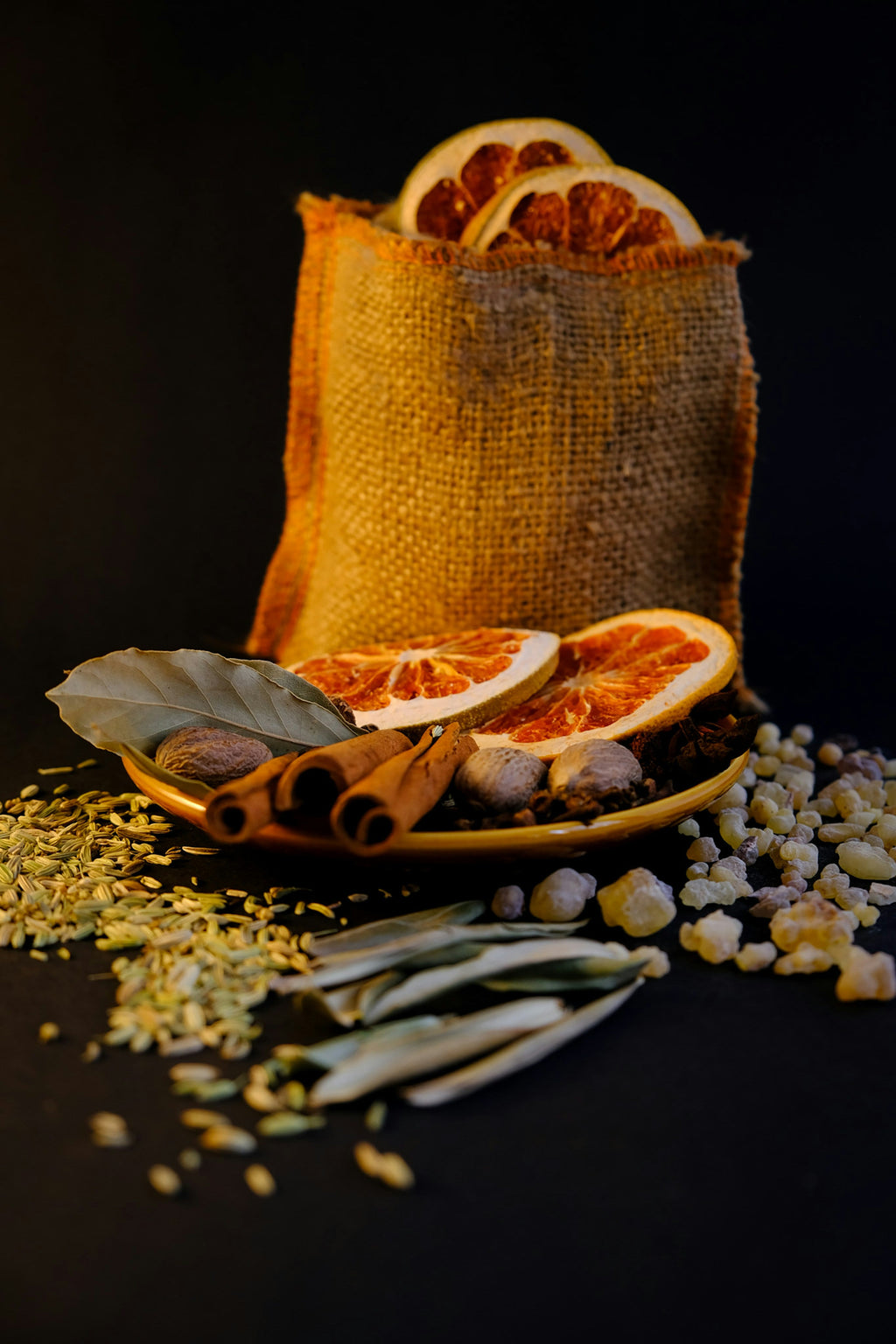 Dried orange, fennel seed, cinnamon and herbs representing the citrus-fennel profile of Spice Czar Greek Sausage Seasoning. Photo by Asli Dokuzeylul via Unsplash, used under the Unsplash License.