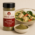Ground Makrut Lime Leaves 4 oz Spice Czar shaker beside a bowl of green curry with rice and a dish of the ground leaves