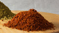 Aleppo pepper flakes showing the dominant red-orange texture of Spice Czar Honey Aleppo Pepper Seasoning. Photo by Veganbaking.net via Wikimedia Commons, CC BY-SA 2.0.