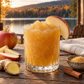Serving suggestion: Maple Ginger Apple Cider slushy with complementary fruit and autumn lake scenery.