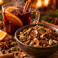 Illustrative serving suggestion: a coarse blend of cinnamon chips, orange peel, allspice, cloves, green cardamom and star anise beside a warm mulled drink. Garnishes are not included.