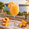 Serving suggestion: Peach Bellini slushy with matching fresh fruit in a lakeside setting.