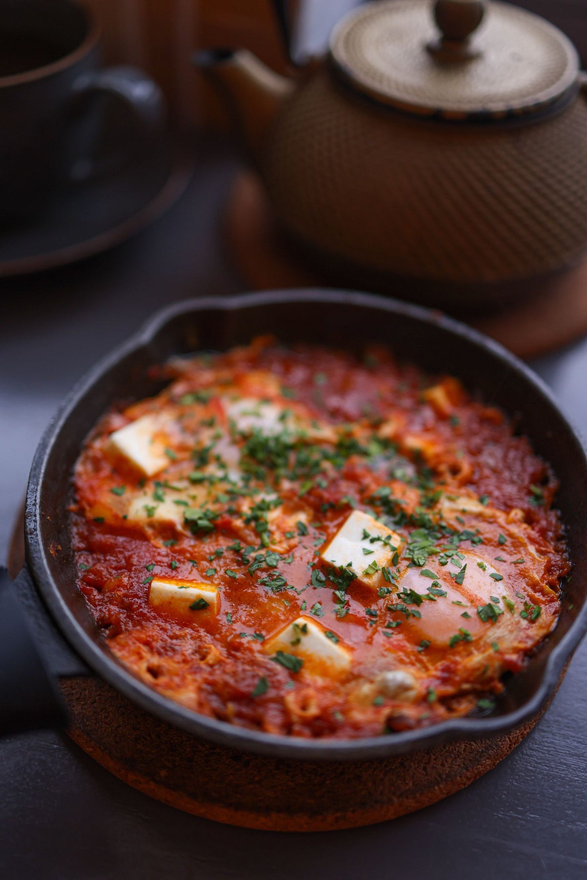 Serving suggestion for Shakshuka Seasoning: skillet eggs in tomato sauce with herbs and feta. Photo by Valeria Boltneva/Pexels; not a photograph of the dry blend.