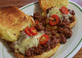 Serving suggestion: sloppy joe sandwiches on toasted buns with cheese and sliced peppers. Photo by jeffreyw, CC BY 2.0, via Wikimedia Commons; not a photograph of the dry seasoning.