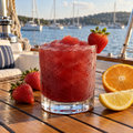 Serving suggestion: Strawberry Sangria slushy with matching fresh fruit in a lakeside setting.