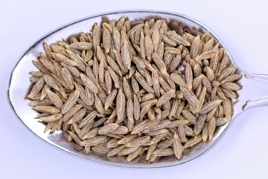 High-resolution close-up of whole cumin seeds on a spoon, accurately representing Spice Czar Whole Cumin Seeds. Photo by Marek Ruczaj via Pexels, free to use.