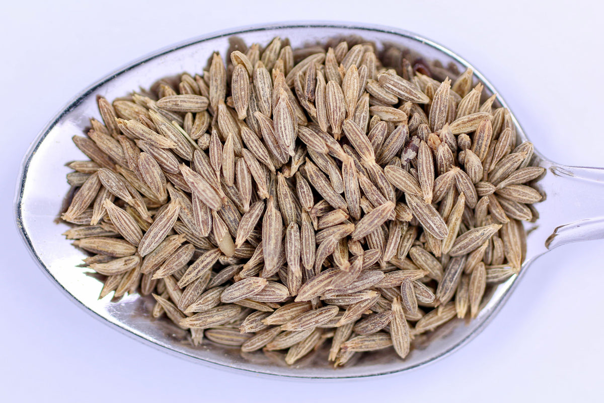 High-resolution close-up of whole cumin seeds on a spoon, accurately representing Spice Czar Whole Cumin Seeds. Photo by Marek Ruczaj via Pexels, free to use.